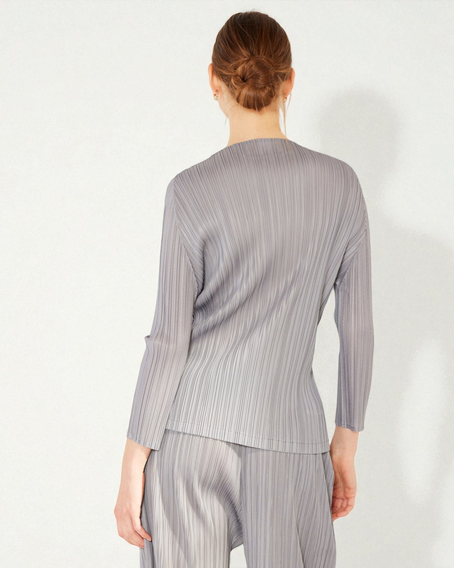 Person wearing a gray striped outfit on a white background