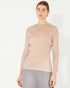 Woman wearing a beige ribbed sweater on a white background