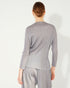 Person wearing a gray striped outfit on a white background