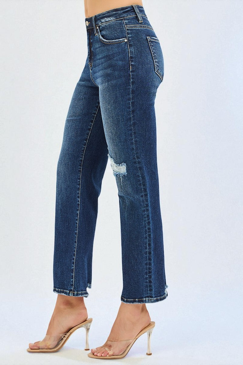 Blue jeans with a slight distressed look worn by a person on a white background