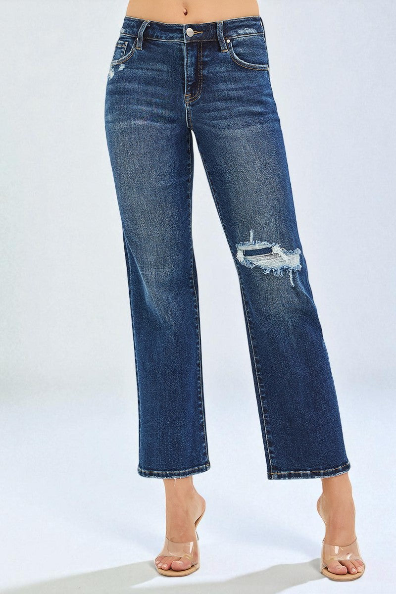 Blue jeans with slight distressing on a light gray background