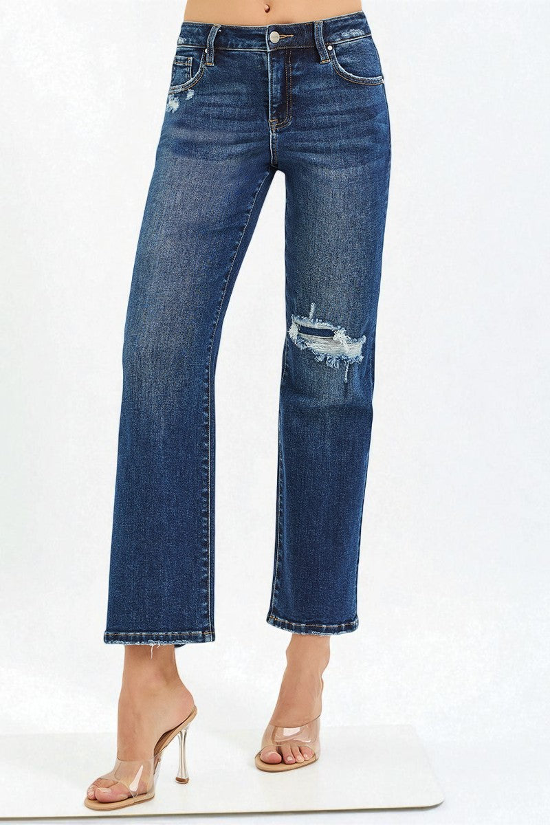Blue jeans with slight distressing on a white background