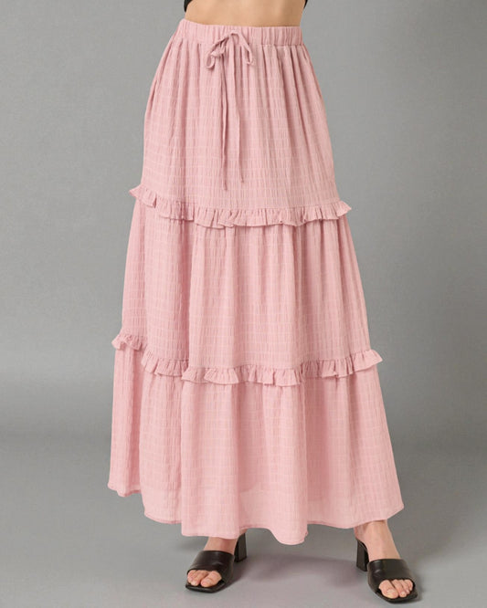 Pink tiered skirt on a gray background