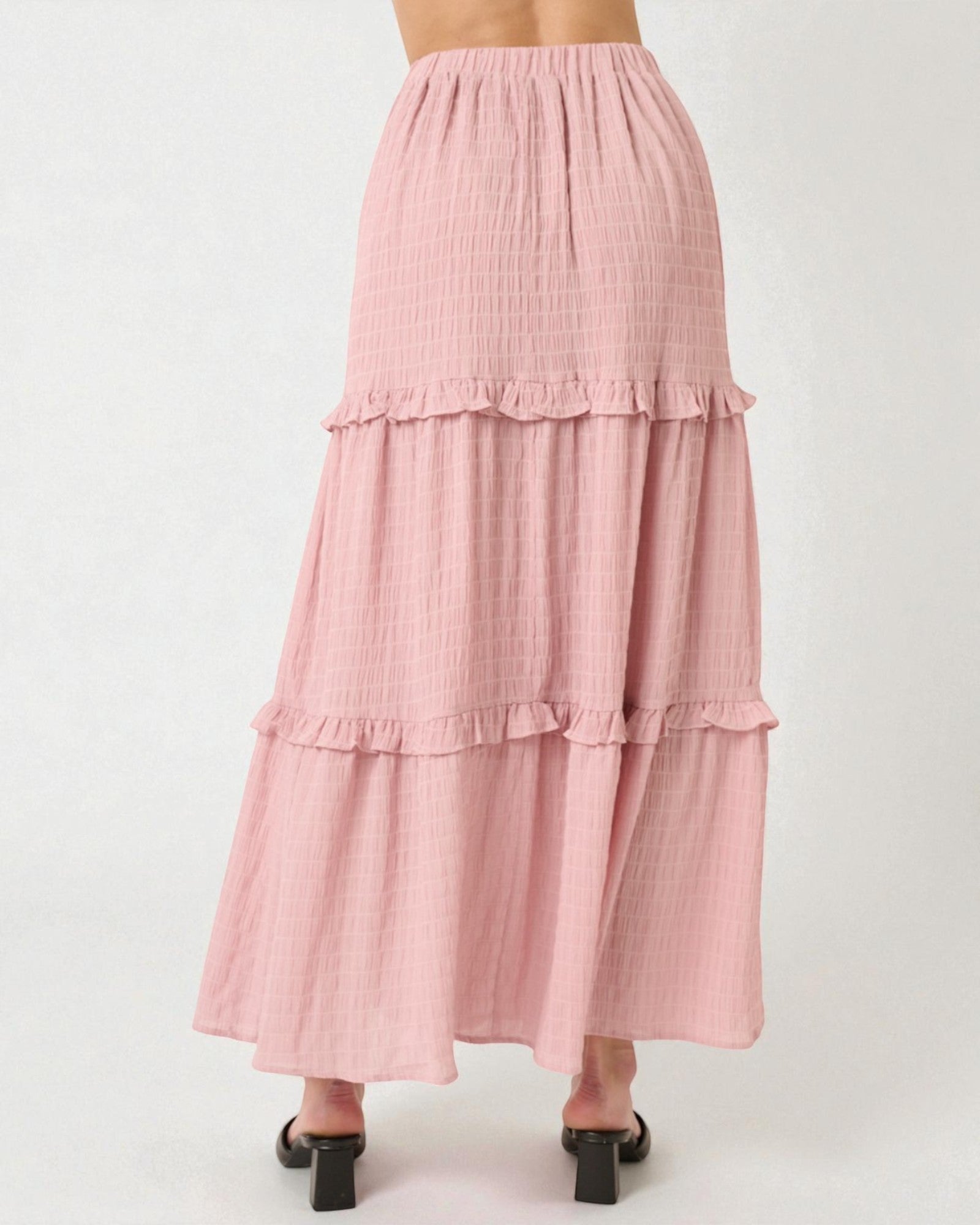 Pink tiered skirt on a white background