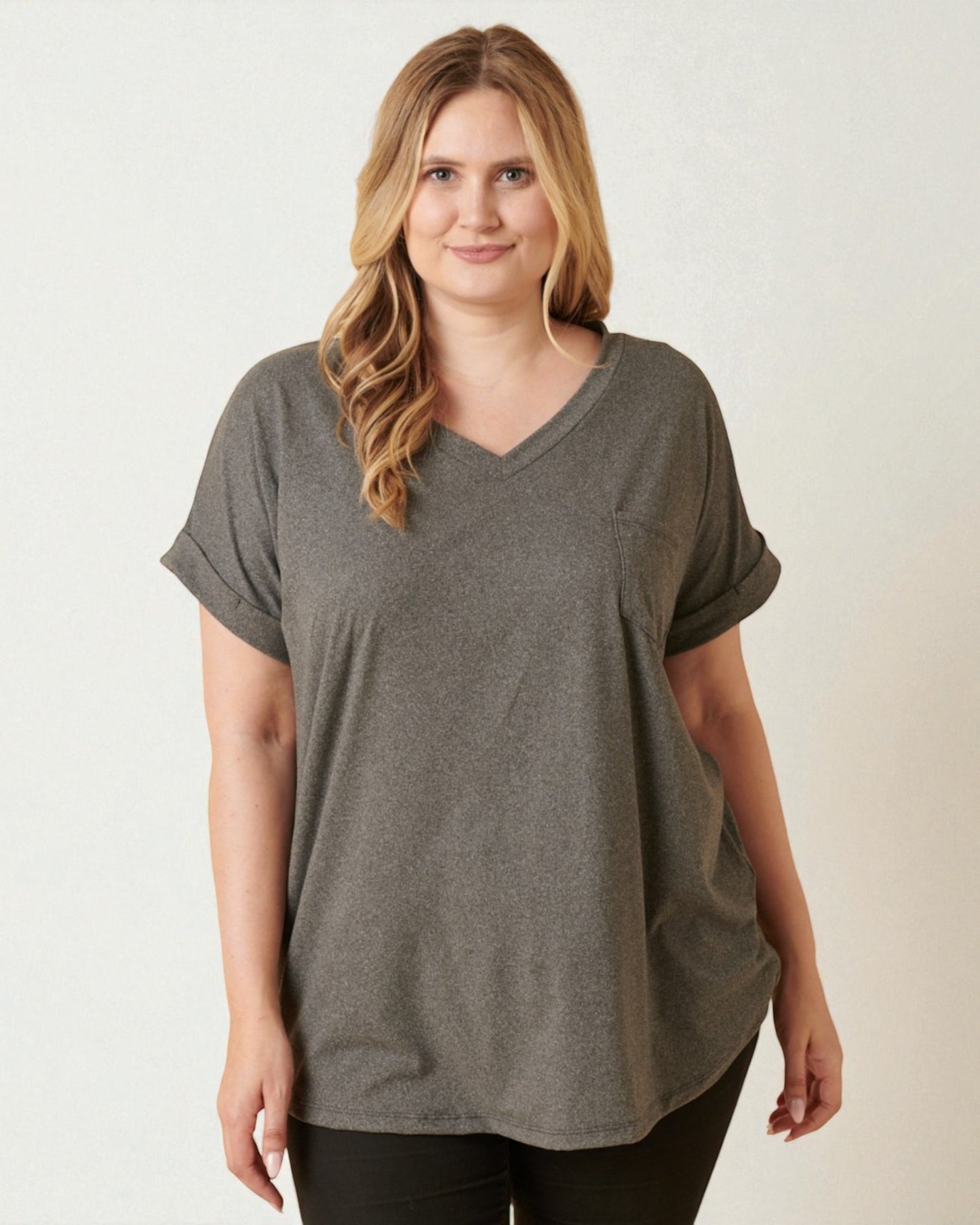 Woman wearing a gray t-shirt against a white background