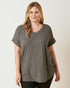 Woman wearing a gray t-shirt against a white background