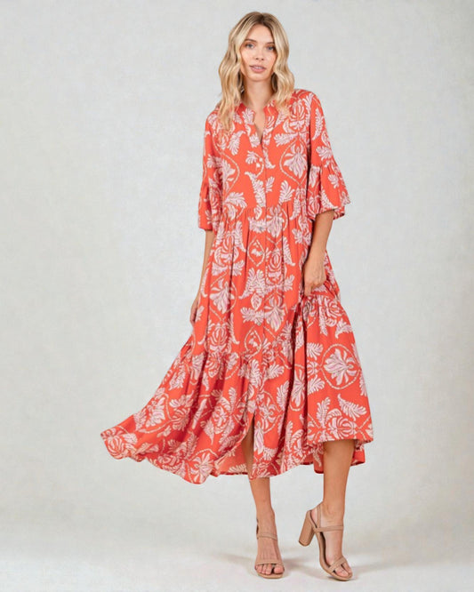 Woman wearing a red floral dress on a white background
