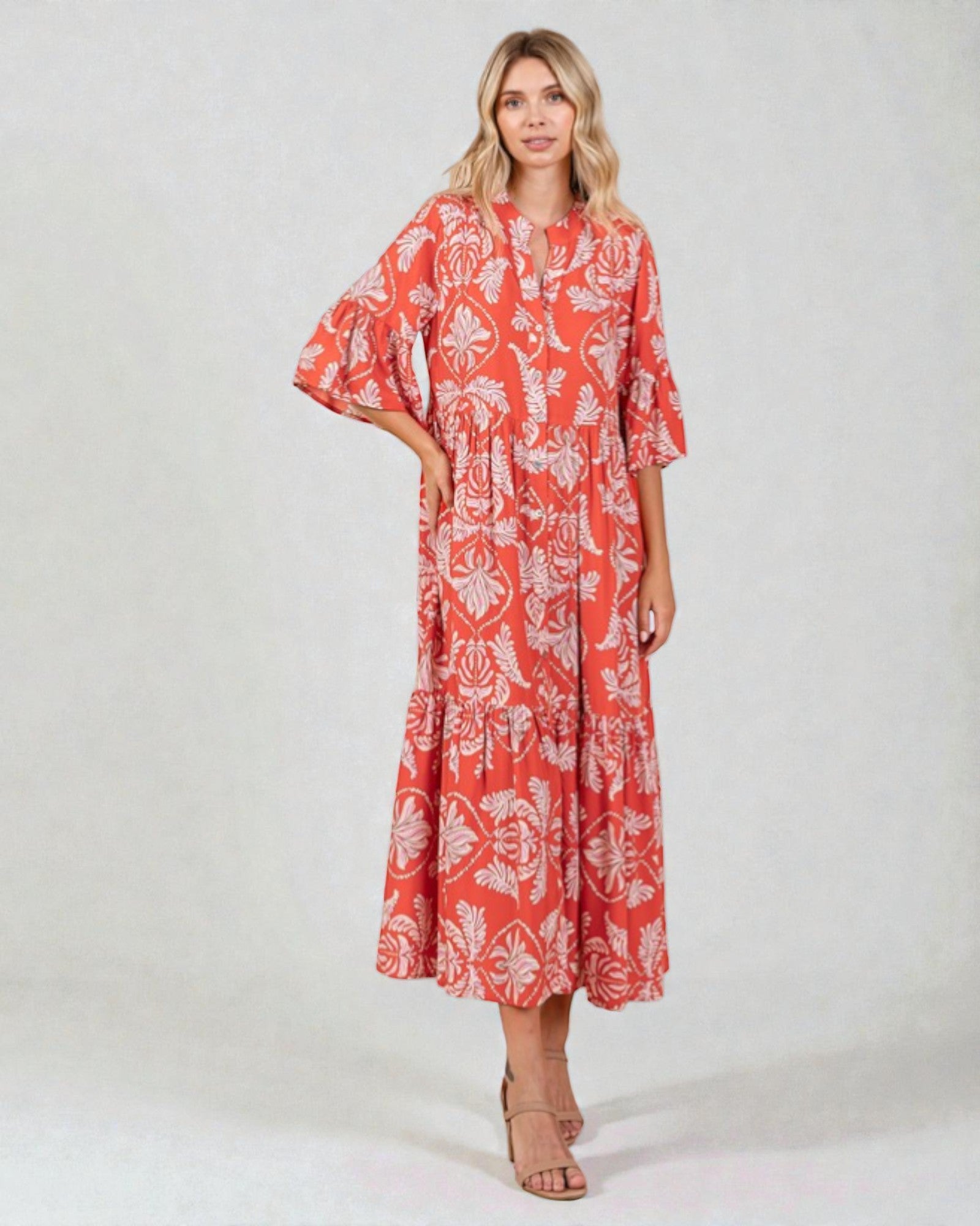 Woman wearing a red floral dress on a white background