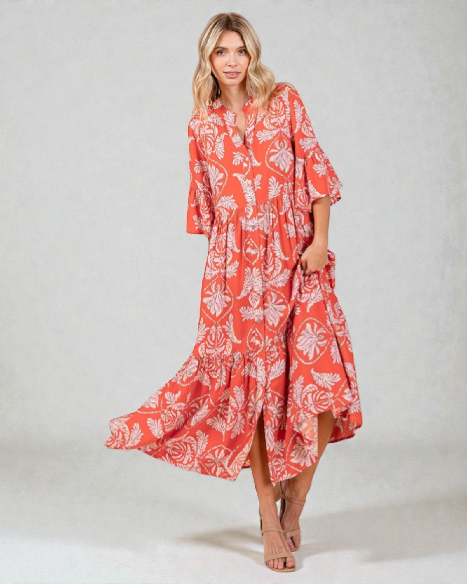 Woman wearing a red floral dress on a white background