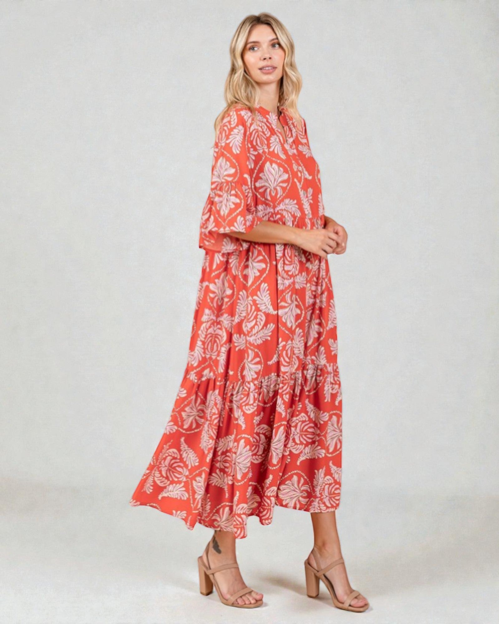 Woman wearing a red floral dress on a white background