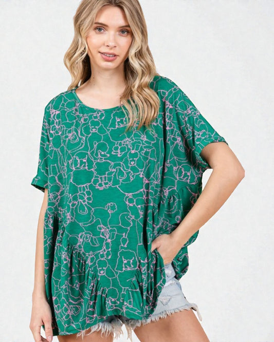 Woman wearing a green patterned top on a white background