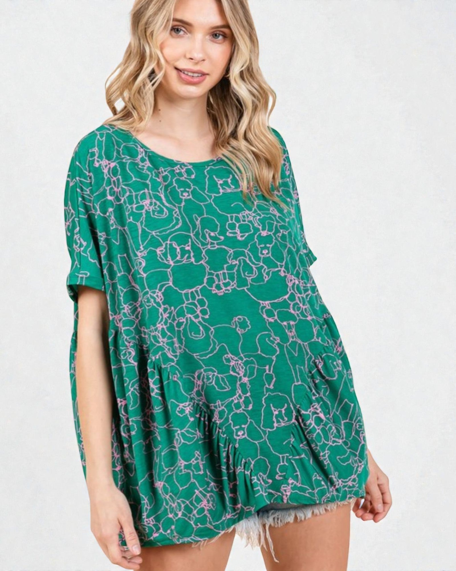 Woman wearing a green floral patterned dress on a white background
