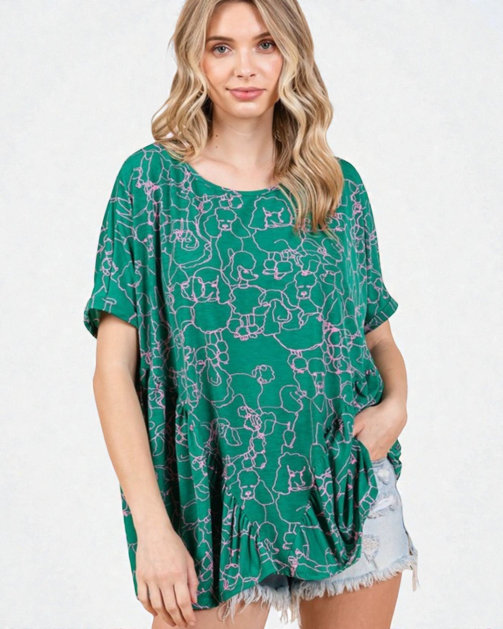 Woman wearing a green floral patterned top on a white background