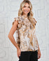Woman wearing a patterned sleeveless top against a light background