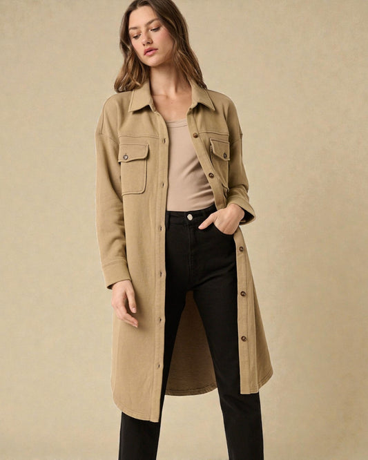Woman wearing a beige trench coat on a beige background