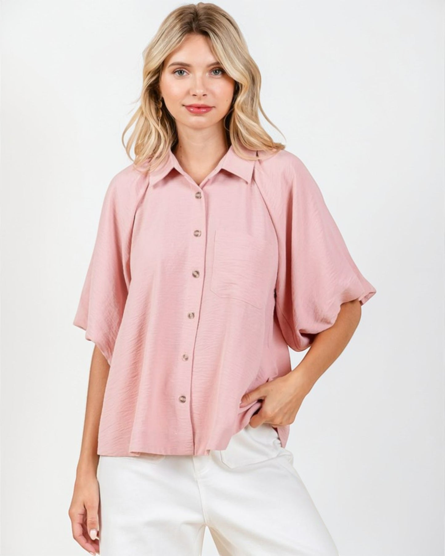 Woman wearing a pink blouse with a white background