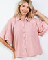 Woman wearing a pink blouse with short sleeves on a white background