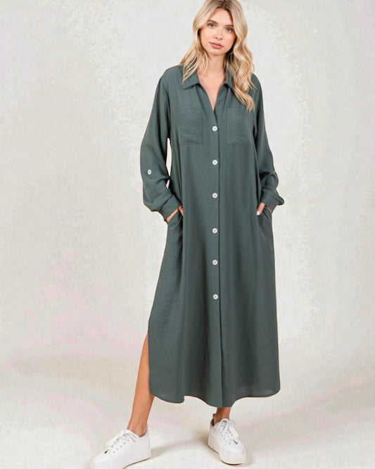 Woman wearing a long green dress with white sneakers on a light background