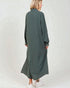 Woman wearing a long green dress on a white background
