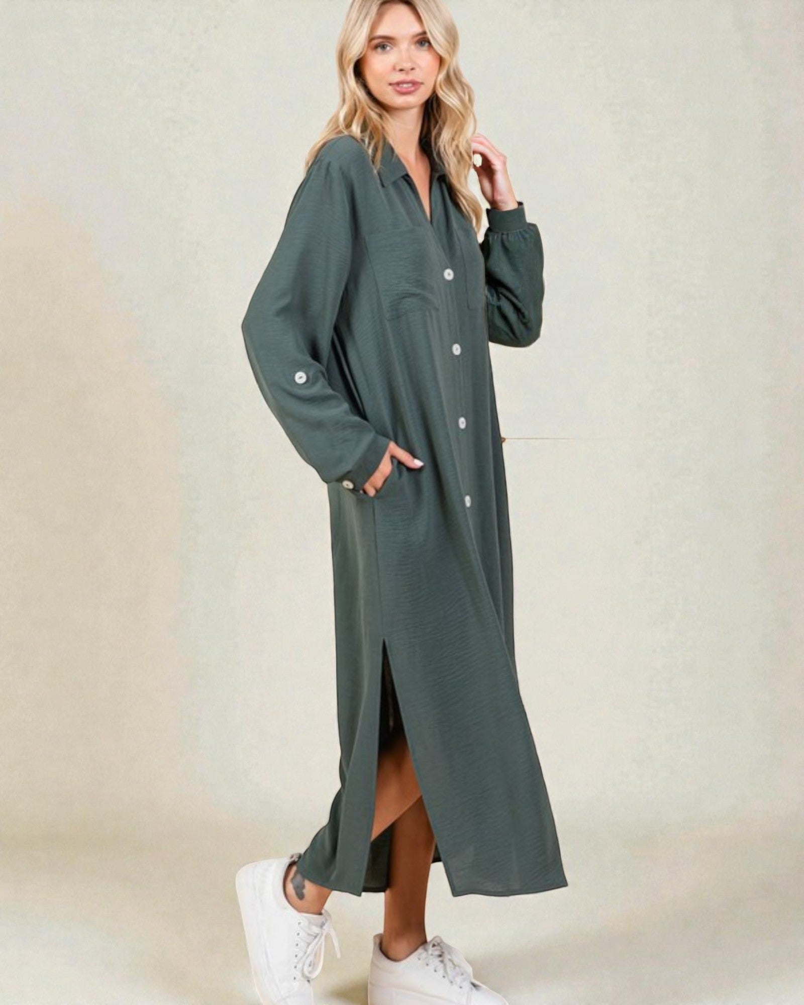 Woman wearing a long green dress with a blurred background