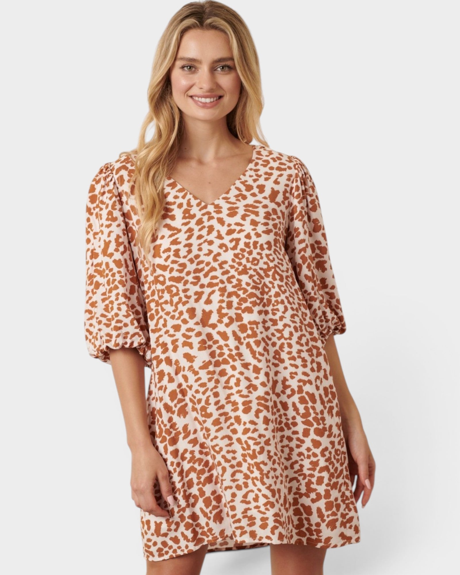Woman wearing a leopard print dress on a white background