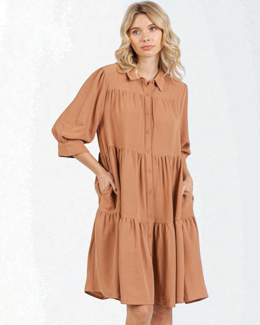 Woman wearing a brown dress on a white background