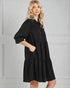Woman wearing a black dress against a gray background