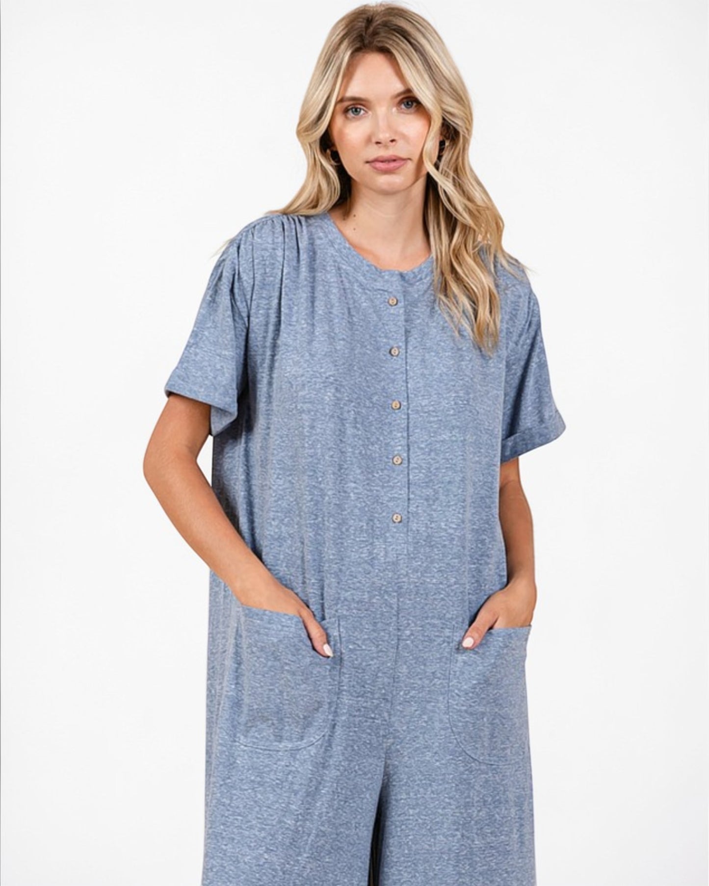 Woman wearing a blue jumpsuit on a white background