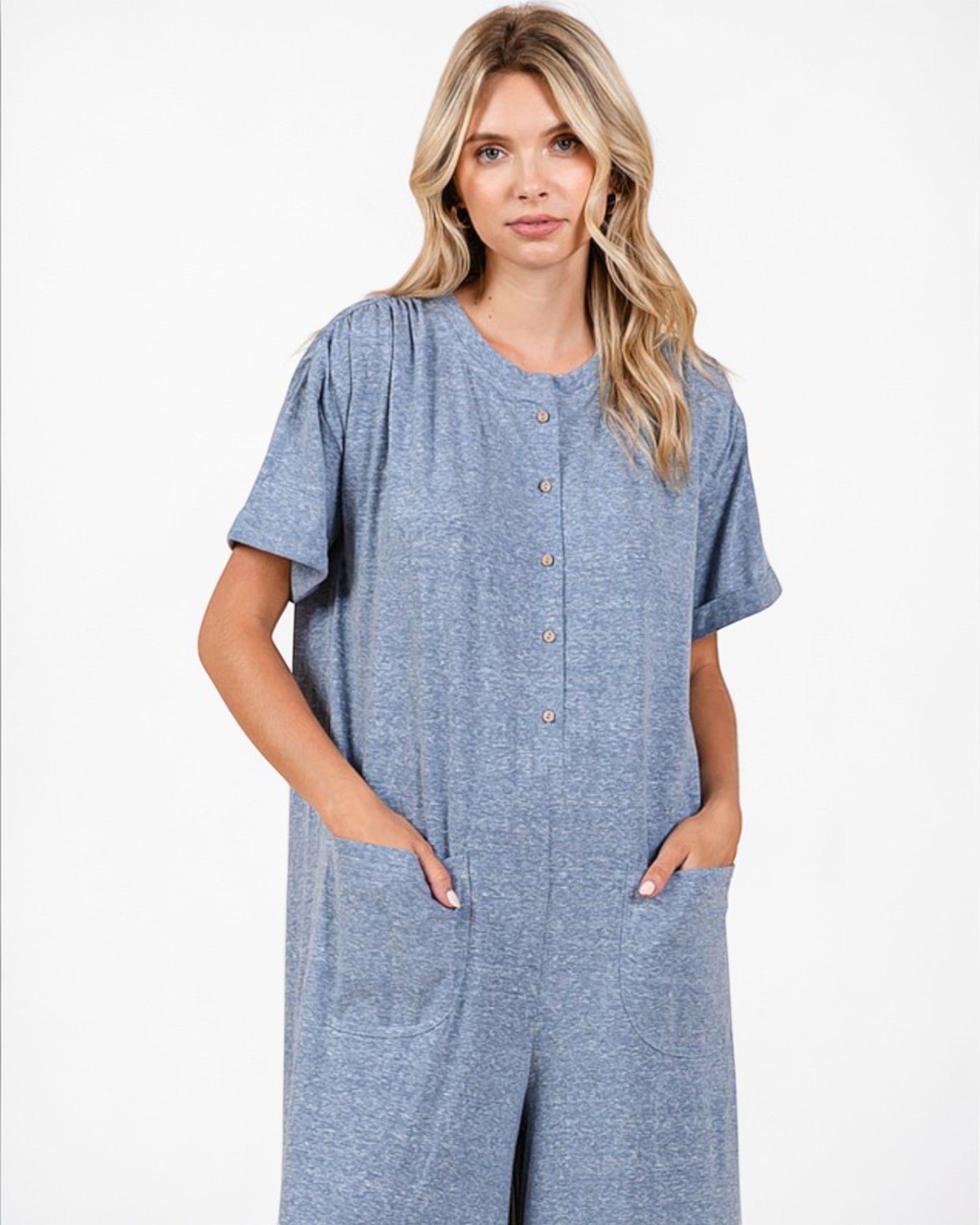 Woman wearing a blue jumpsuit on a white background