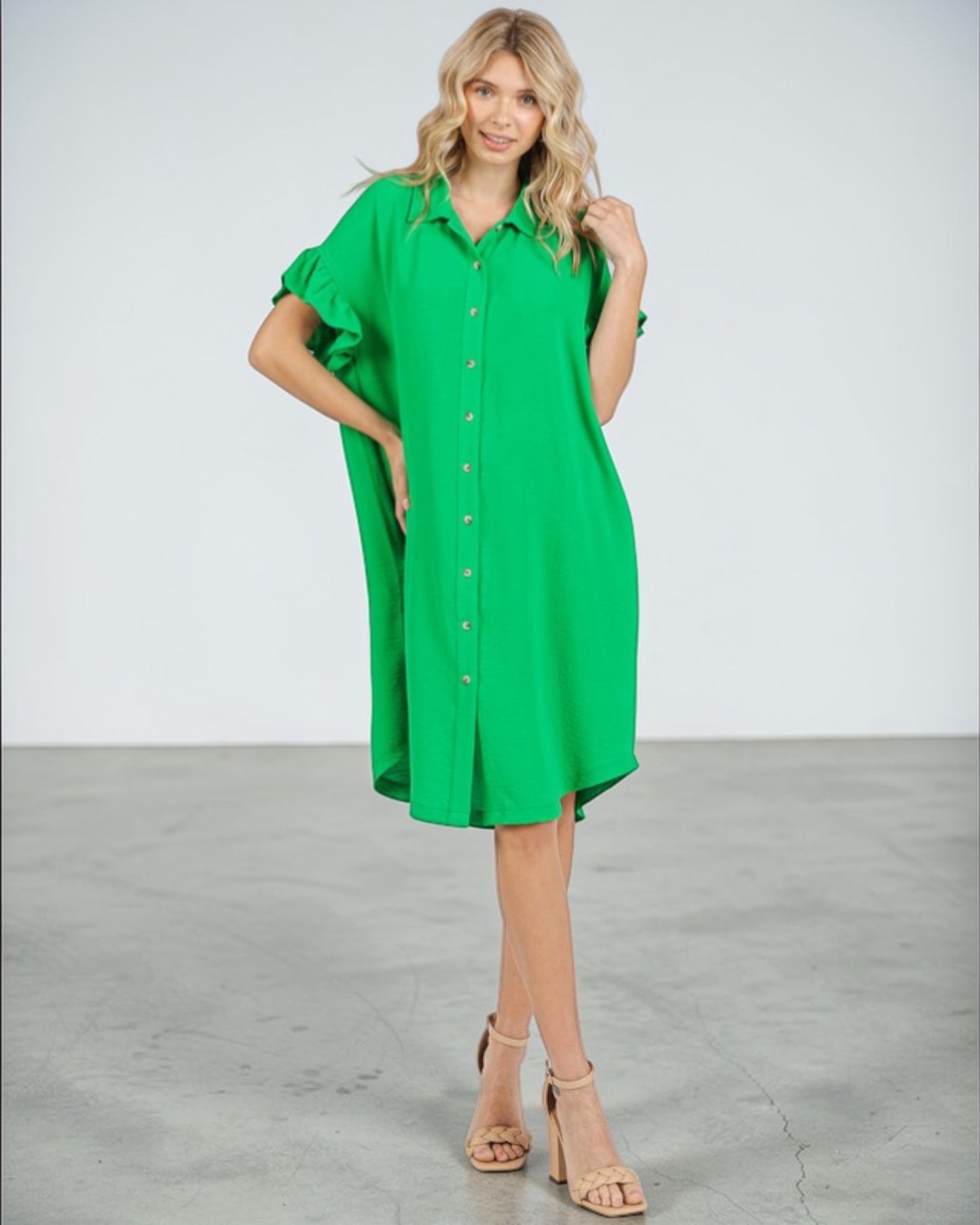 Woman wearing a green dress against a white background
