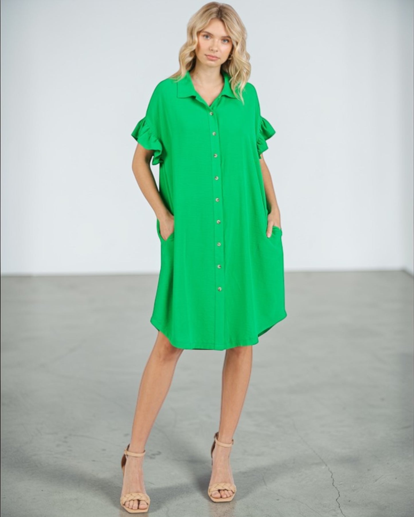 Woman wearing a green dress against a white background