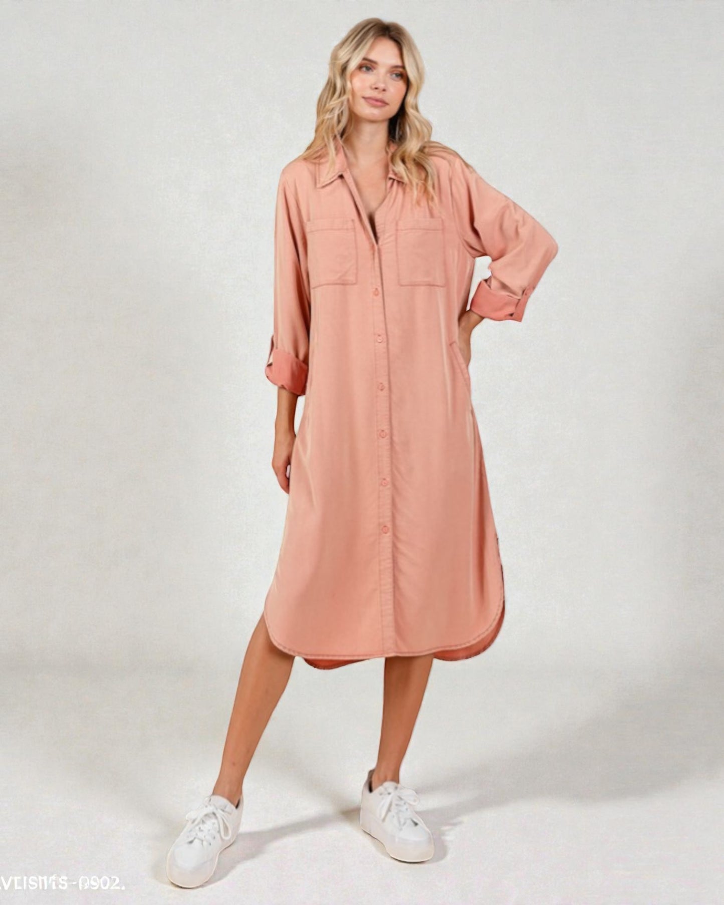 Woman wearing a pink dress with a white background