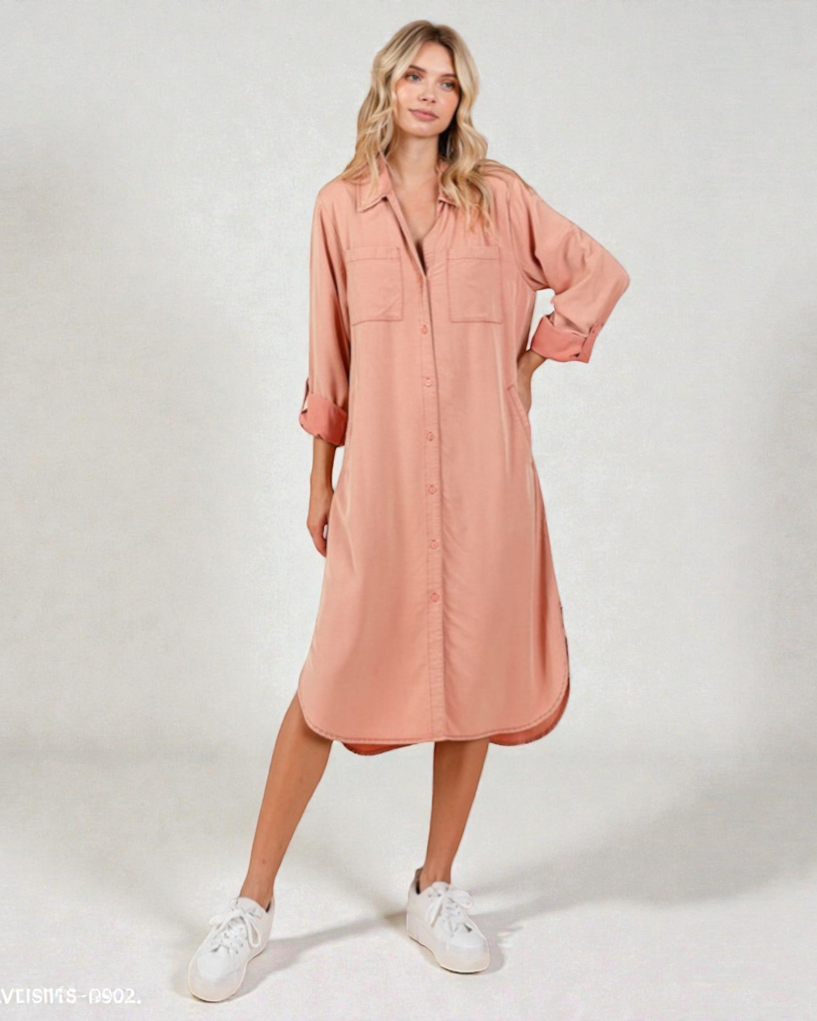 Woman wearing a pink dress with a white background