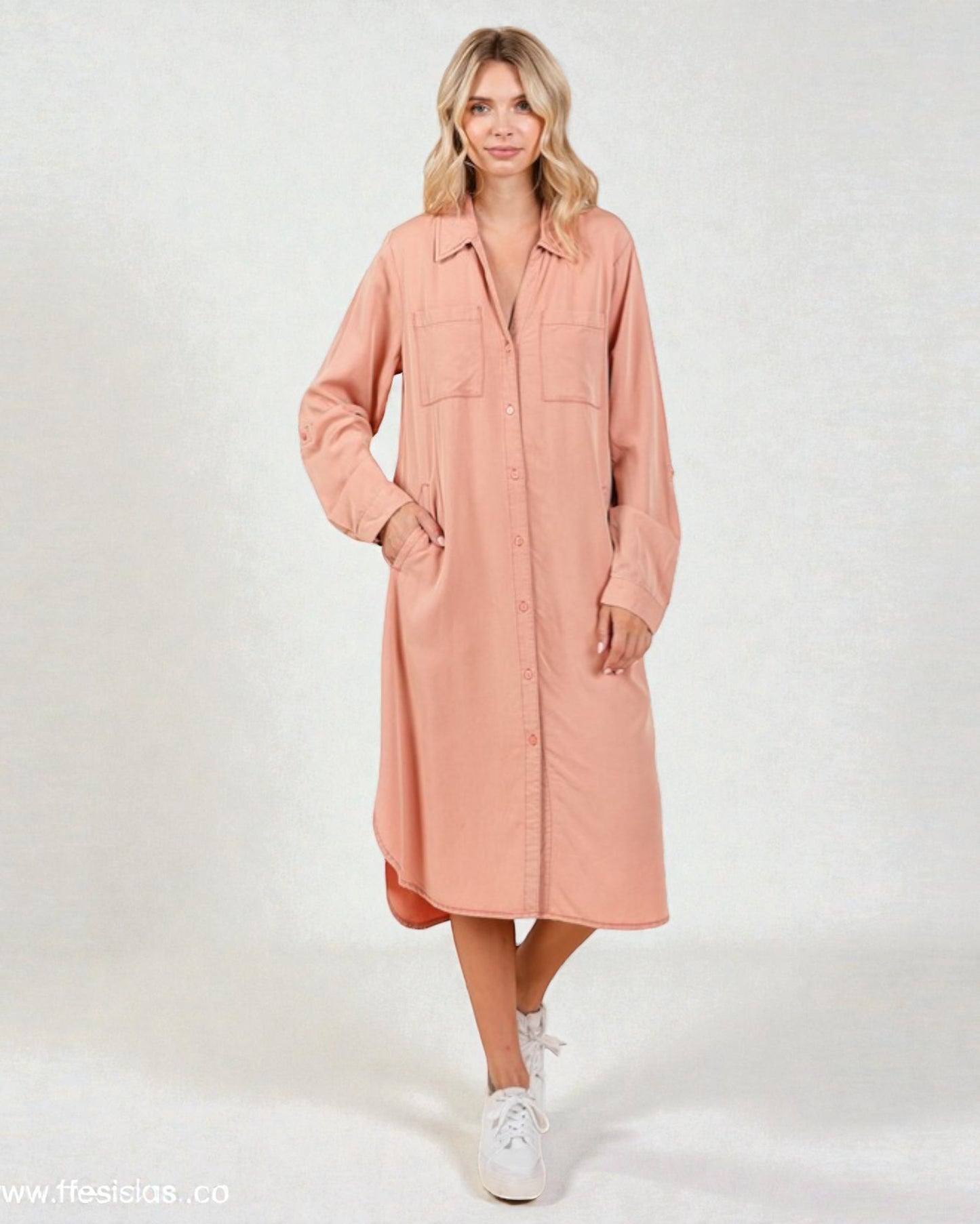 Woman wearing a pink dress with a white background