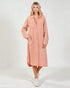 Woman wearing a pink dress with a white background