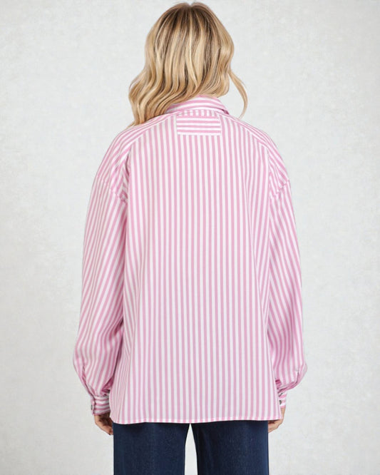Person wearing a pink and white striped shirt on a plain background