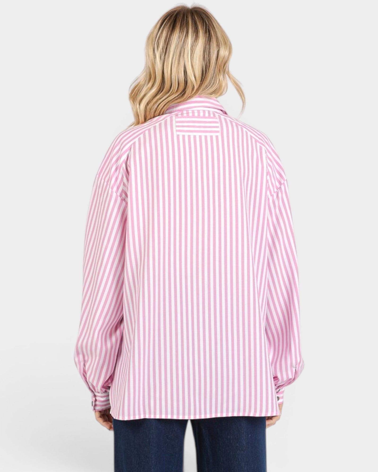 Person wearing a pink and white striped shirt on a white background
