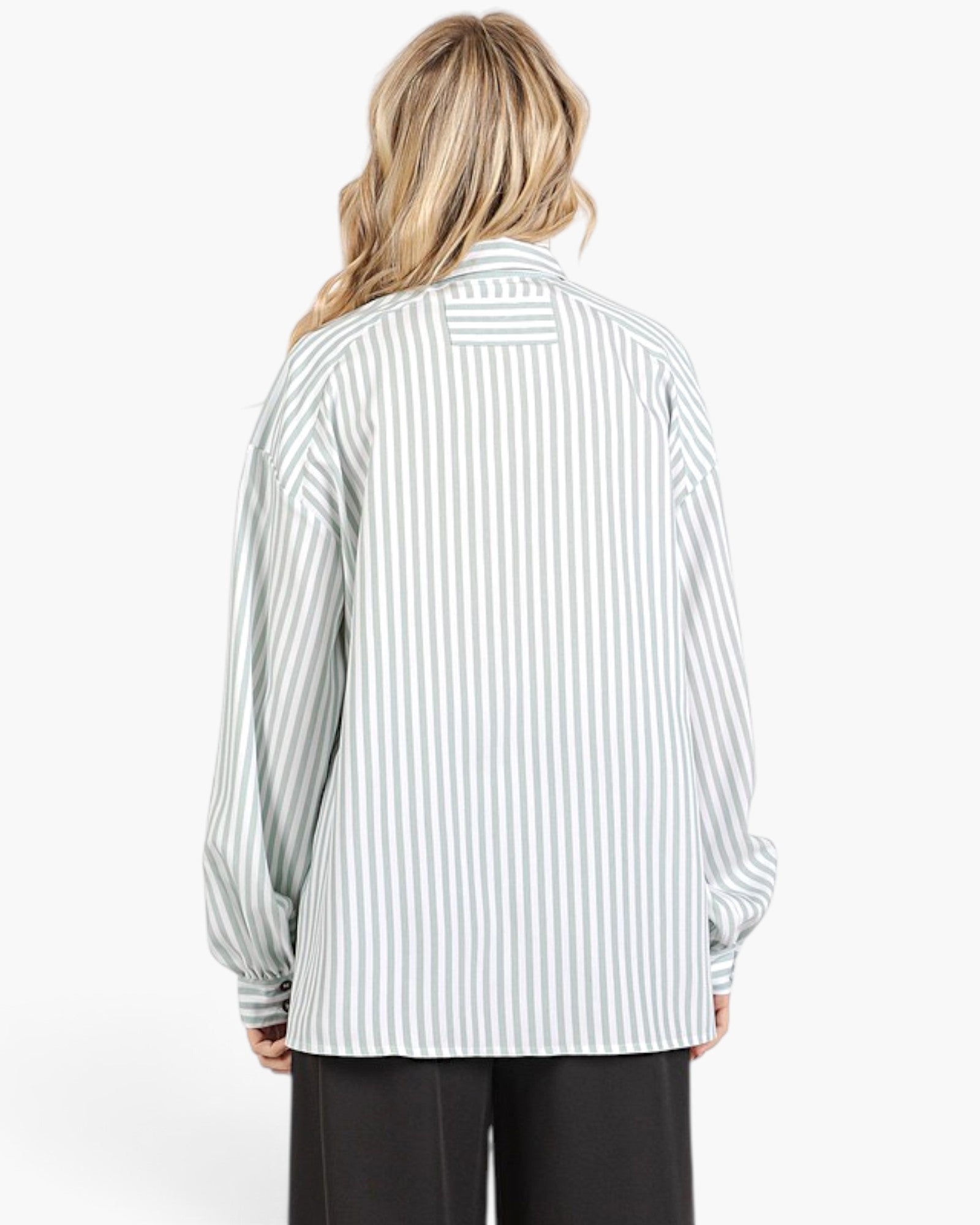 A model shown from the back wearing a light green and white vertically striped button-up shirt with a relaxed fit, paired with black pants, against a plain white background.