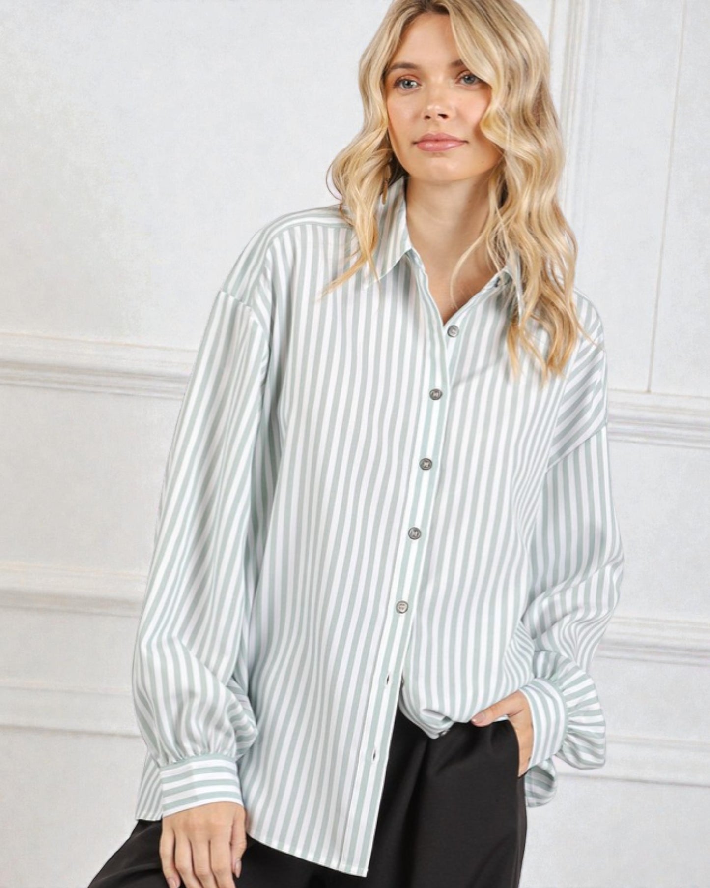 Woman wearing a striped shirt against a white background