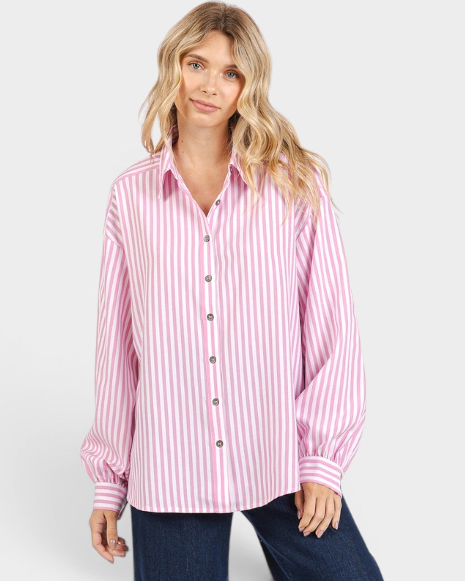 Woman wearing a pink and white striped shirt on a white background