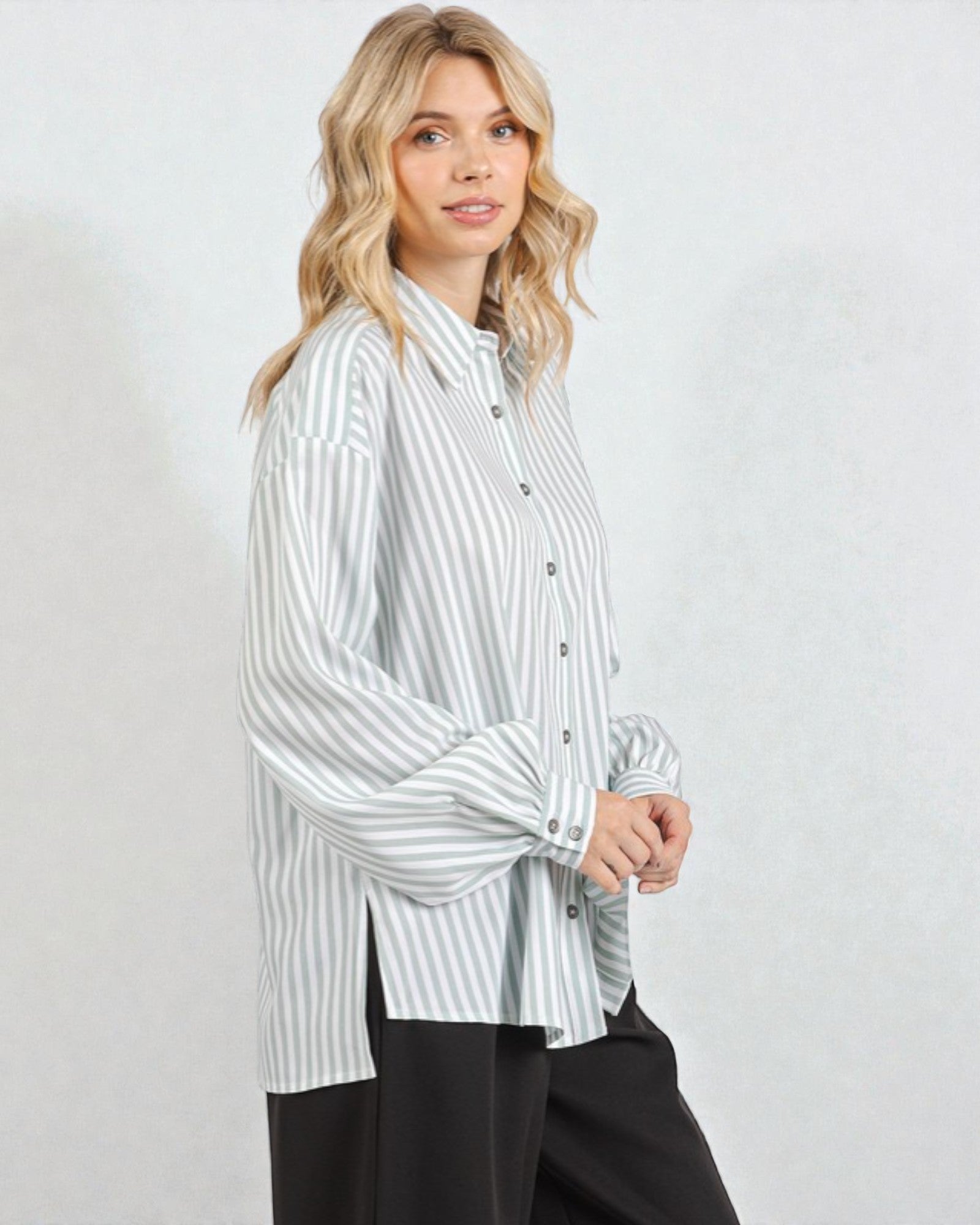Woman wearing a striped shirt against a plain background
