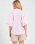 Person wearing a pink striped shirt and beige shorts on a white background