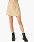 A beige corduroy cargo mini skirt with a button closure and side flap pockets, shown on a model wearing black combat boots against a light gray background.