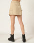 Beige skirt worn by a person on a white background