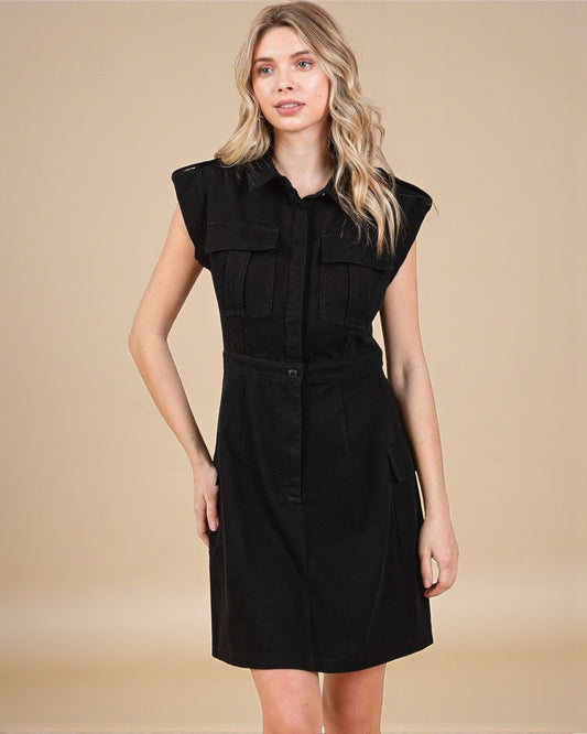 Woman wearing a black sleeveless dress against a beige background