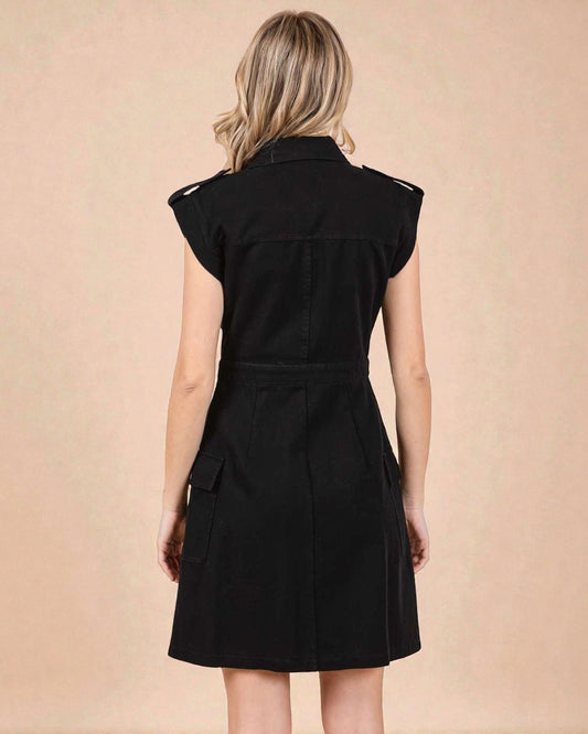 Woman wearing a black dress against a beige background