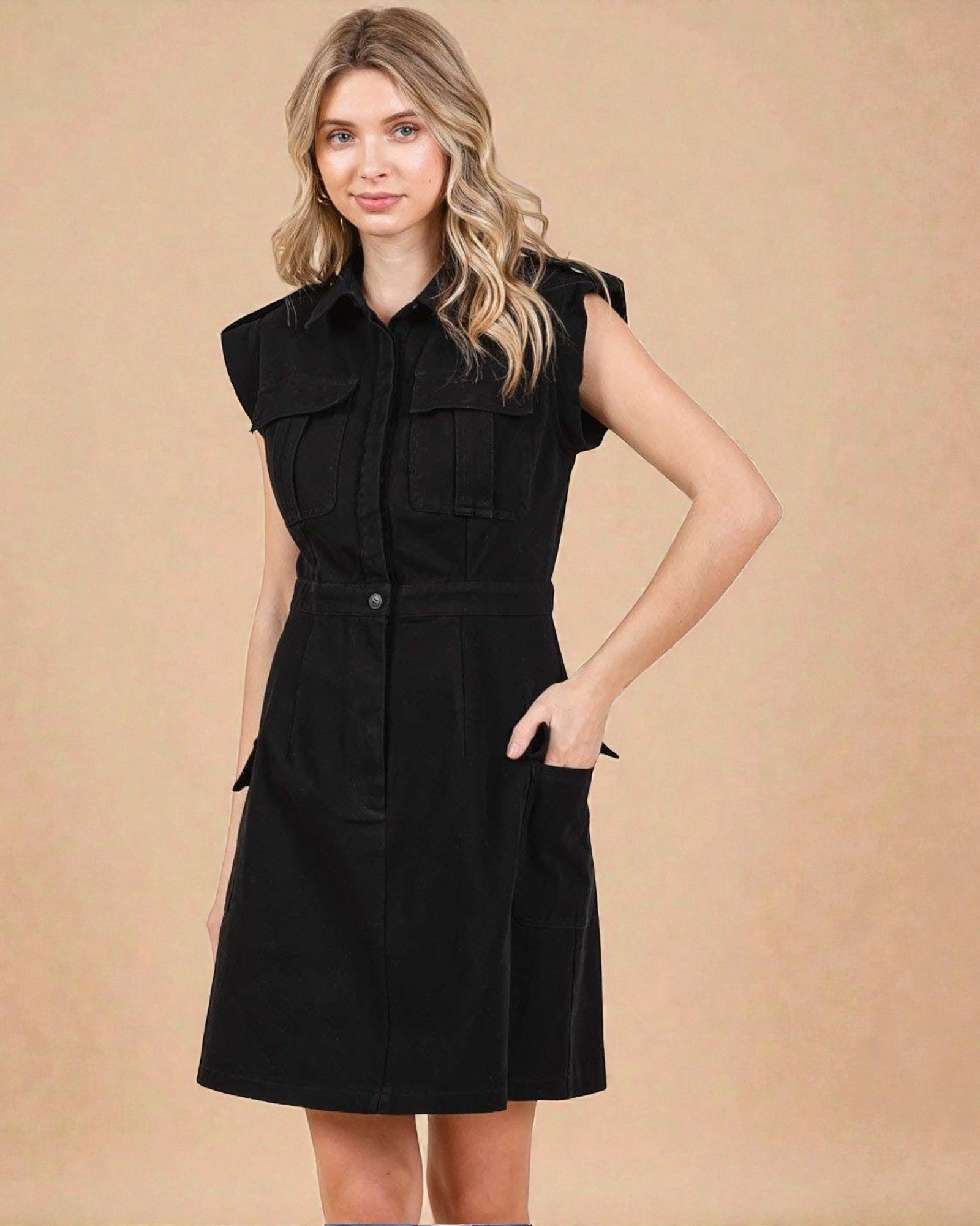 Woman wearing a black sleeveless dress against a beige background