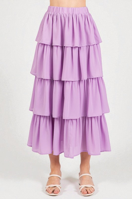 Purple tiered skirt worn by a person on a white background