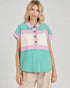 Woman wearing a colorful striped shirt against a plain background
