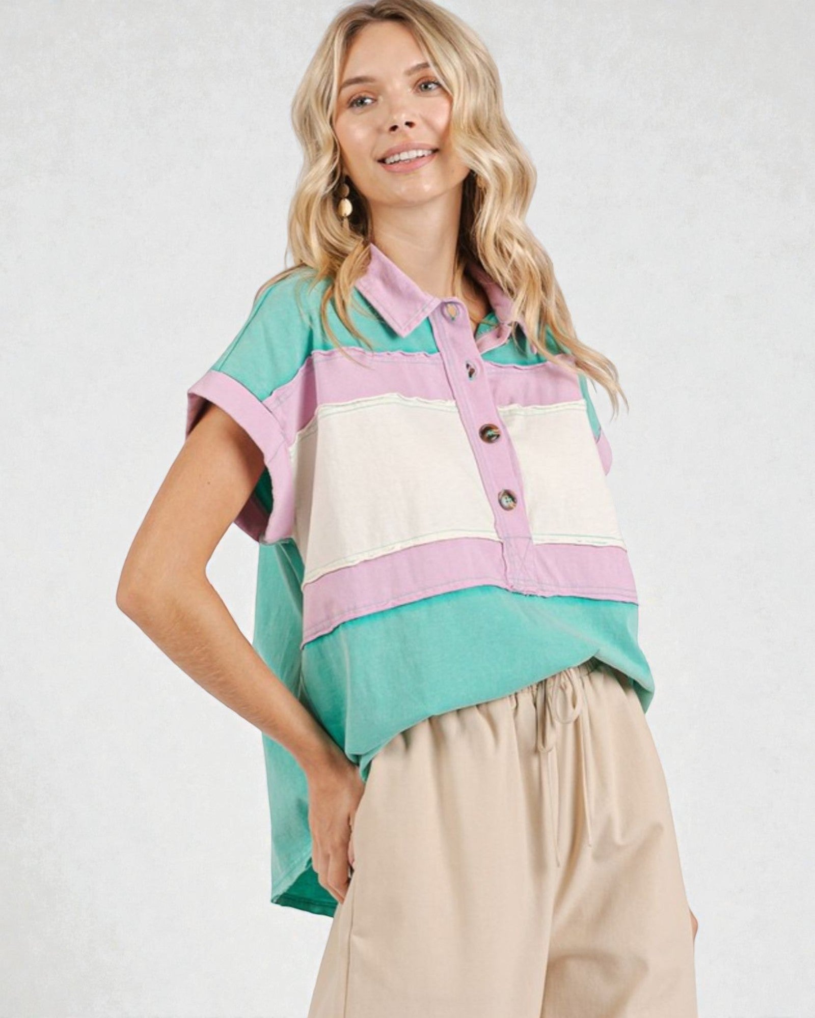 Woman wearing a colorful striped shirt with a white background